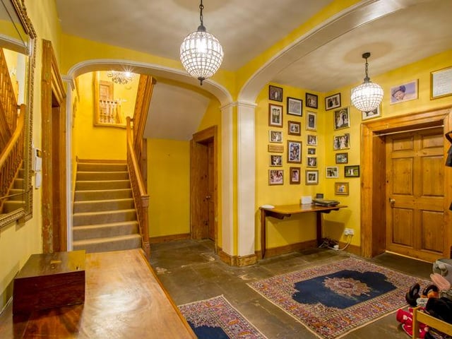 The oak entrance door leads to a large reception hall with moulded archways, stone flag floors and cloak hooks.