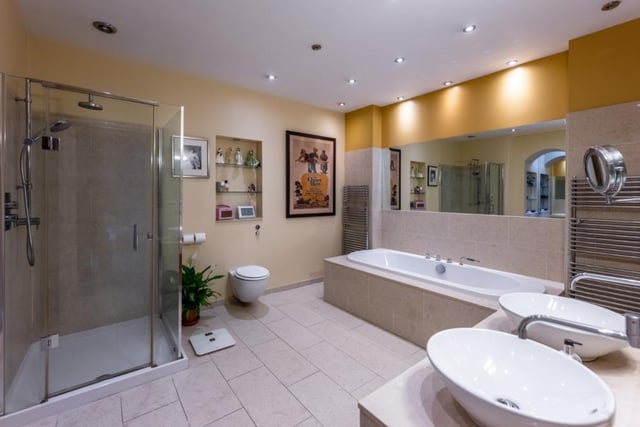 The en-suite bathroom is generous in size and features a large double end bath, twin Duravit wash basins set in a vanity unit, and an over-size walk-in shower.