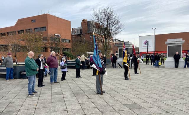 Standard bearers and members of the public observe the two minutes silence at Hartlepool War Memorial in Victory Square, at 11am on Wednesday. Picture by FRANK REID