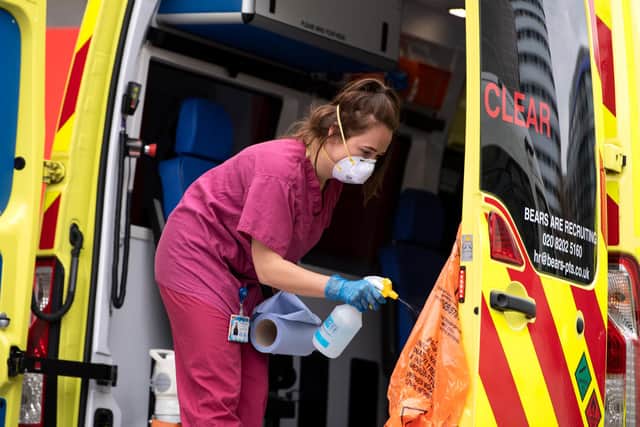 A hospital worker cleans an ambulance - (Photo by Justin Setterfield/Getty Images)