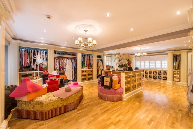 The principal dressing room has fully fitted, hand crafted furniture including a central dressing console and wardrobes and shoe racks inspired by the Christian Louboutin boutique in Paris.