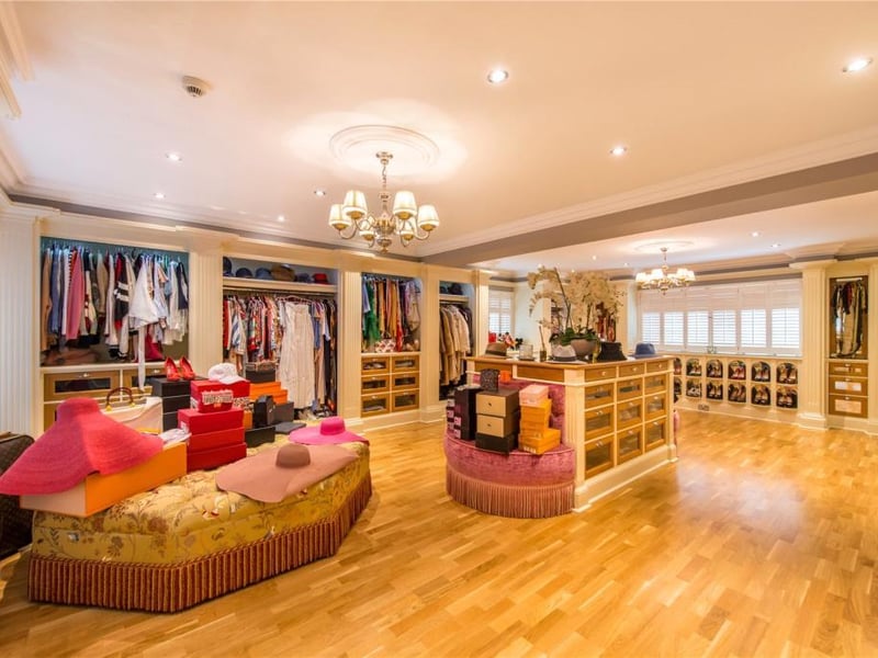 The principal dressing room has fully fitted, hand crafted furniture including a central dressing console and wardrobes and shoe racks inspired by the Christian Louboutin boutique in Paris.