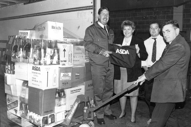 Tom Montain from Wincanton Distribution helps with the first load from the newly-opened warehouse serving the North of England.  Also pictured are goods in checker Brian Johnson, Personnel Manager Heather Lord and driver Paul Hogan. But who can tell us more about this photocall in October 1993?