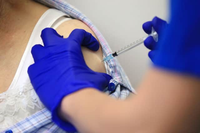 Nurse Practitioner Terri Welch administers a dose of the Pfizer-BioNTech Covid-19 vaccine to a patient. (Photo by Lindsey Parnaby / AFP) (Photo by LINDSEY PARNABY/AFP via Getty Images)