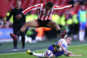 Sheffield United's Iliman Ndiaye challenged by Wigan Athletic's Omar Rekik: Danny Lawson/PA Wire.