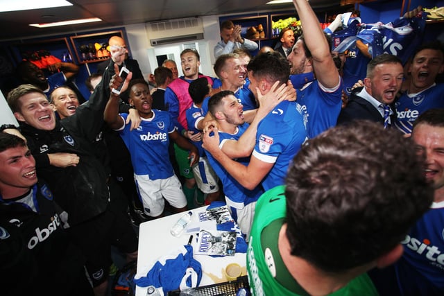 Pompey players and staff celebrate in the dressing room.