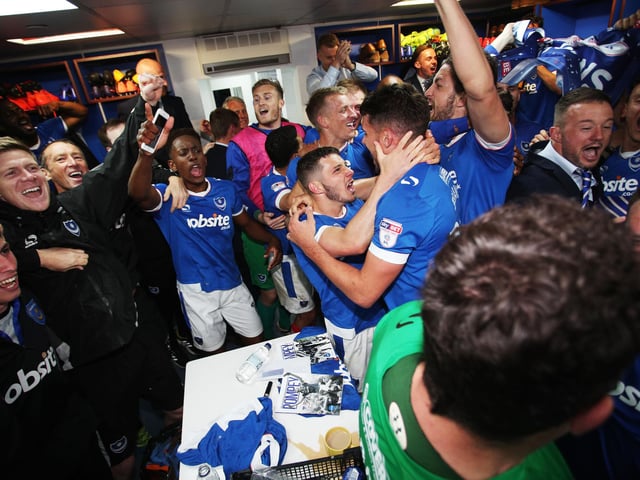 Pompey players and staff celebrate in the dressing room.