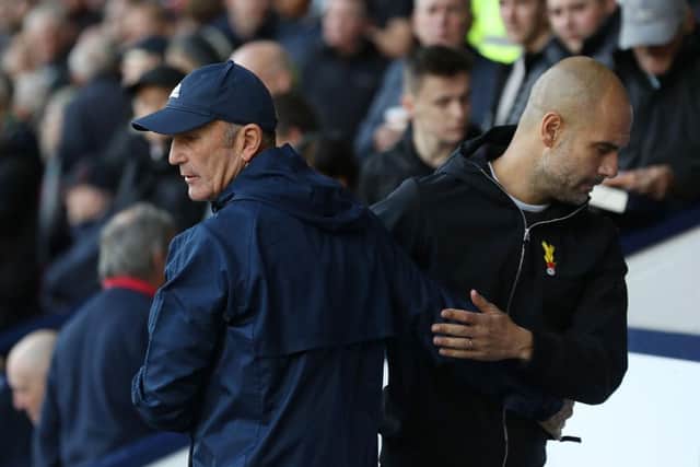 Tony Pulis, then manager of West Bromwich Albion and Man City's Pep Guardiola shake hands on prior to the Premier League match between West Bromwich Albion and Manchester City at The Hawthorns on October 28, 2017.  (Photo by Matthew Lewis/Getty Images)