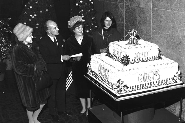 Goldberg's department store's giant Christmas cake is unveiled in 1965.