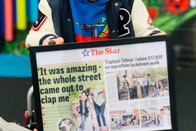 Tobias is presented with some gifts from Paces school, including his framed Sheffield Star front page, from earlier in the summer