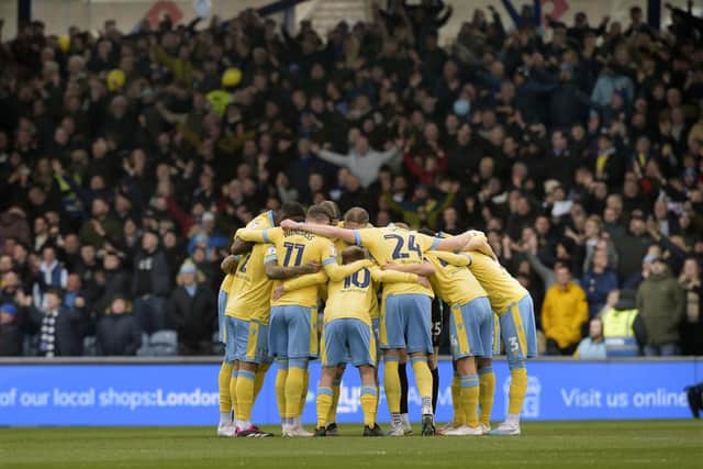 Owls huddle against a backdrop of the jubilant Wednesday fans at Portsmouth   Pic Steve Ellis