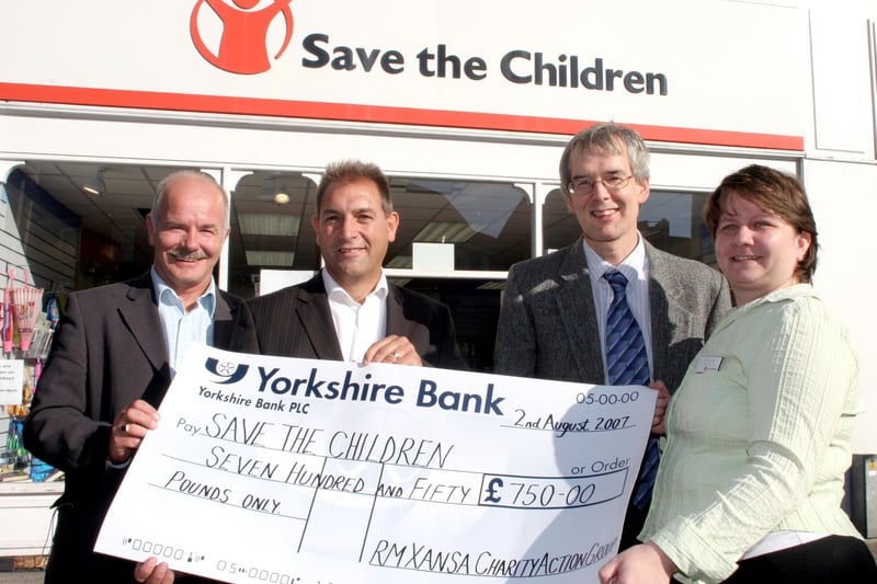 Tom smith, Mick Dowson and Martin Cox representing Xansa who are presenting £750 to Save the Children's sales manager Julie Edwards.