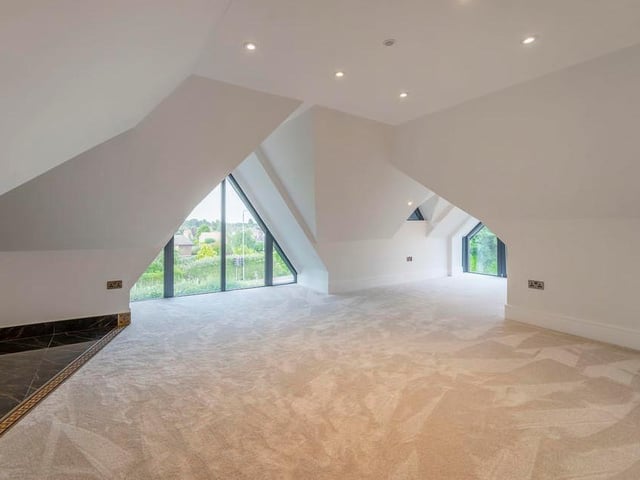 One of the two large bedrooms on the second floor. There is also a lengthy walk-in wardrobe.