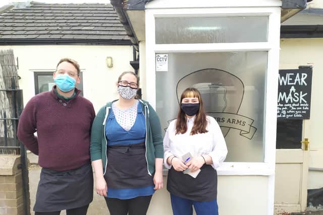 All masked up at The Brothers arms: Assistant manager James Hughes, manager Emma France and barmaid Ruby Hayworth.