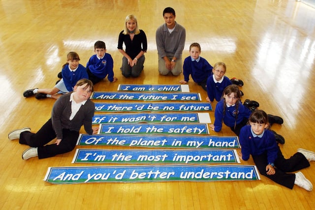 These Year 4 pupils are pictured with a giant banner of a poem in 2003. Who can tell us more about the occasion?