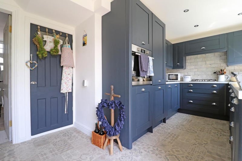 The kitchen offers many units for storage and ample worktop space.