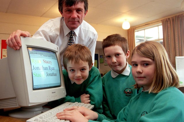 Athelstan Primary School headteacher Tony Woodward looks on as pupils Sally Yeomans (9),Ryan Harrison (8) and Jonathan Bloodworth (7) try out their new computer won in a competition organised by ASDA in 1999