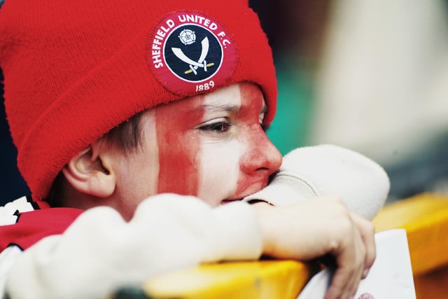 A young United fan watches his side during the FA Cup semi-final match against Arsenal at Old Trafford in April 2003.