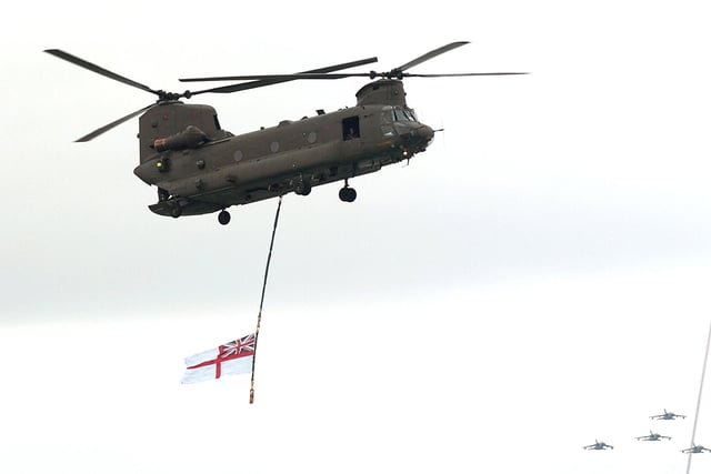 A Chinook flies the White Ensign over the sea display arena at IFOS 2005 as a fly-past comes in from the west ( bottom right) 7th July 2005. Picture: Malcolm Wells 053125-140