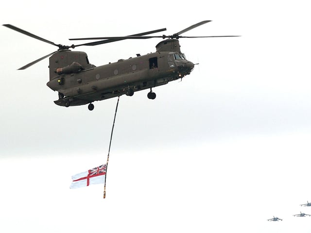 A Chinook flies the White Ensign over the sea display arena at IFOS 2005 as a fly-past comes in from the west ( bottom right) 7th July 2005. Picture: Malcolm Wells 053125-140
