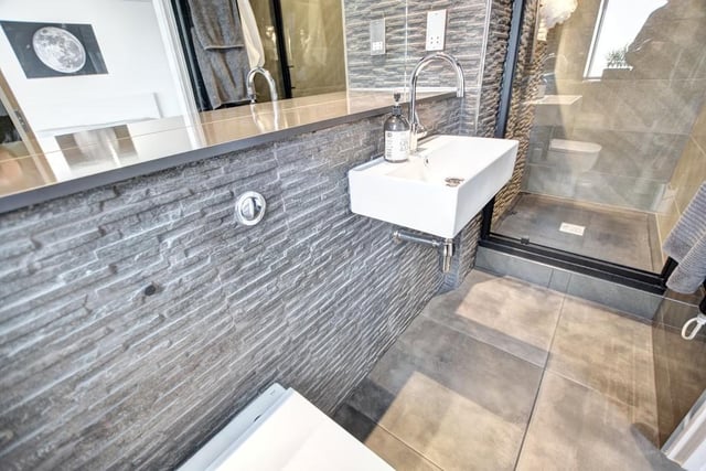 The ensuite shower room has a shower enclosure and wash hand basin with mixer tap