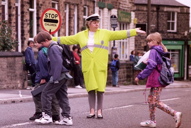 Lollipop Lady Pamela Gascoyne pictured helping children across the busy road at Crosspool, Sheffield, in September 1996.