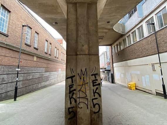 Beneath the concrete ramp to Atkinson's car park