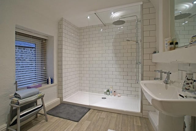 The bathroom features a large walk-in shower area.