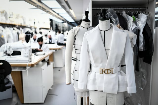 Employees work on couture garments at Christian Dior's Haute Couture fashion house workshop in Paris