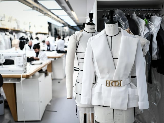 Employees work on couture garments at Christian Dior's Haute Couture fashion house workshop in Paris
