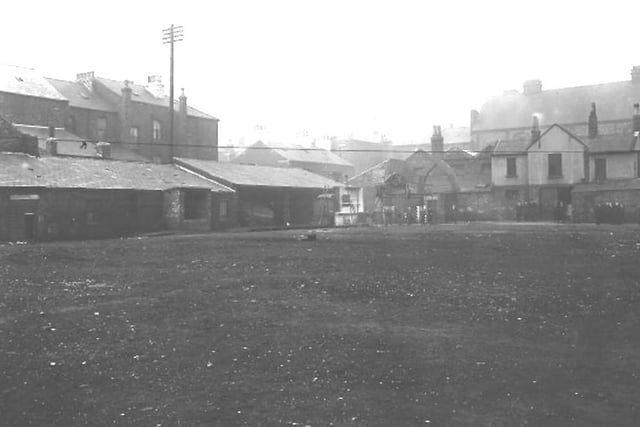 The back of Lynn Street market showing community wash houses used for bathing and washing clothes on the left.