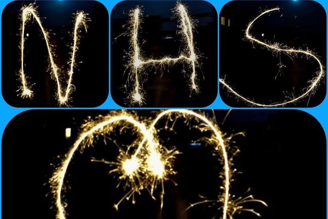 Kelly Lo's son gives his thanks with sparklers. A message and love heart to the NHS.