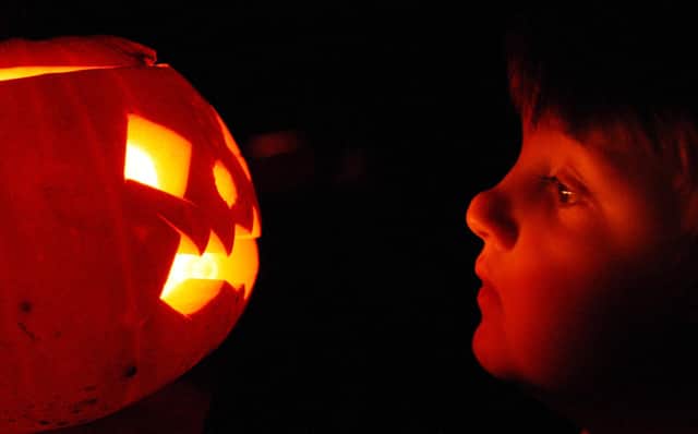 A child enjoys traditional candle-lit Halloween pumpkins. Picture: Peter Macdiarmid/Getty Images.