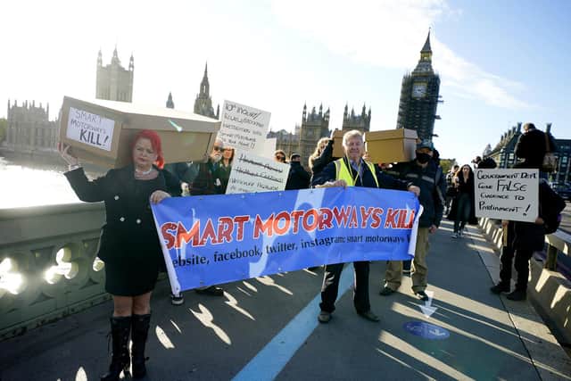 Claire Mercer leads Demonstrators protesting against smart motorways march with coffins across Westminster Bridge to Parliament Square in London. Picture date: Monday November 1, 2021. PA Photo. See PA story TRANSPORT Smart. Photo credit should read: Aaron Chown/PA Wire