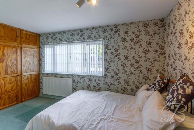 This bedroom boasts fitted wardrobes. The floor is carpeted and there is a window giving excellent views.