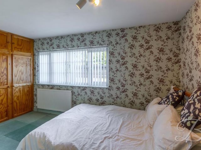 This bedroom boasts fitted wardrobes. The floor is carpeted and there is a window giving excellent views.