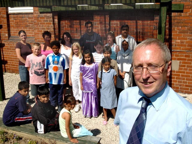 Hucklow Primary School headteacher Roger Simonds, who announced his retirement after 21 years' service, is pictured with pupils past and present.