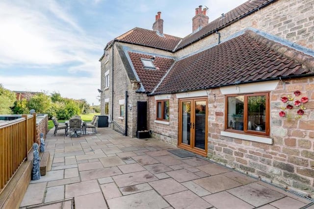 A substantial patio, made of Indian sandstone, runs the full width of the house. It's an attractive space for entertaining family and friends when the weather allows.