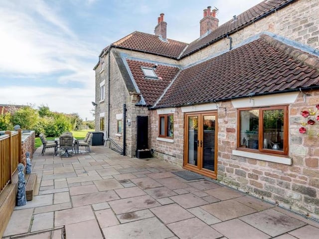 A substantial patio, made of Indian sandstone, runs the full width of the house. It's an attractive space for entertaining family and friends when the weather allows.
