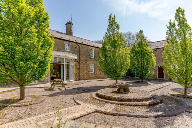 Hoober House has a tree-lined driveway leading up to the front courtyard, providing access to the main property. The driveway continues giving access to a side courtyard and onto the main garden and parking areas.