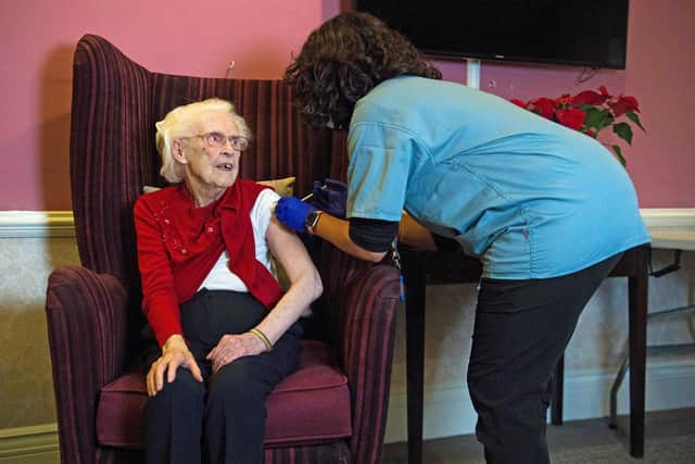 Hundred year-old Nell Prosser receives the Oxford/AstraZeneca Covid-19 vaccine from Dr Nikki Kanani at the Sunrise Care Home in Sidcup, south-east London in January