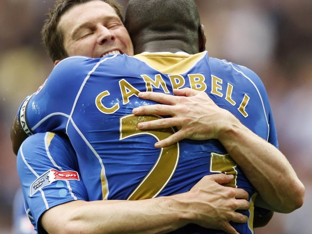 Portsmouth's Sol Campbell hugs teammate Portsmouth's David Nugent after winning the F.A Cup Final against Cardiff. ADRIAN DENNIS/AFP via Getty Images)