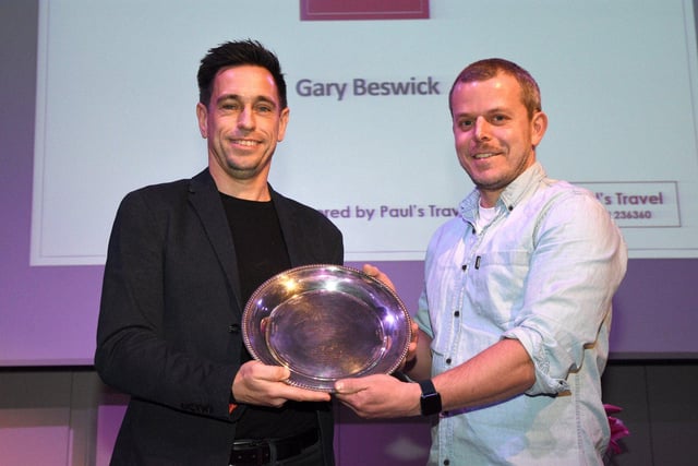 Gary Beswick is presented with his Services to Sport award by  sports committee member Adam Brookes.