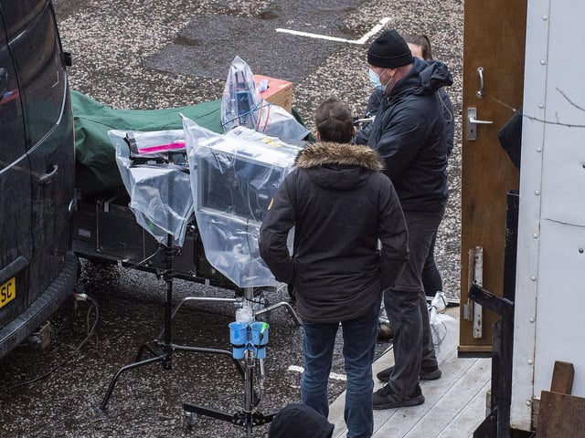 The crew had to protect their equipment against the elements while filming at The Parish Church of St Cuthbert on Thursday.