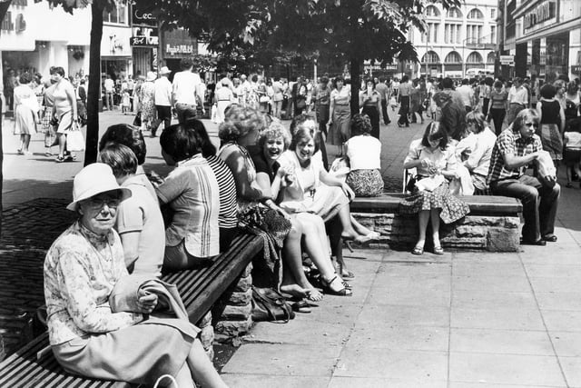People in Sheffield enjoy the sunshine in 1978 by shopping down Fargate.