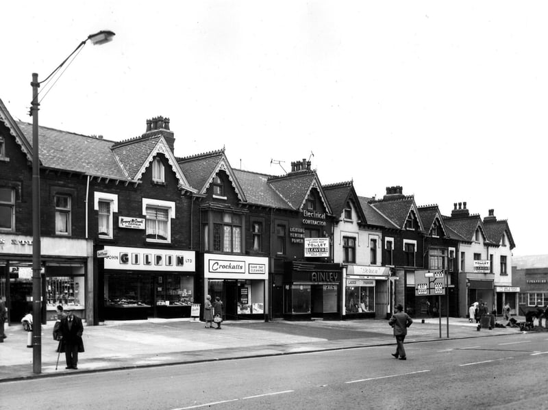 Shops on Roundhay Road, Leeds, in June 1966, including John Gilpin, bakers and confectioners; Crockatt's cleaning; Ainley (Leeds) Ltd., electrical engineers; and Doreen, ladies' fashions.