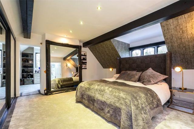The master bedroom boasts a dressing room with fitted wardrobes and an en-suite bathroom