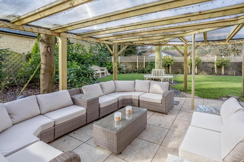 The landscaped rear garden has covered sitting and dining area with remote-controlled patio heaters