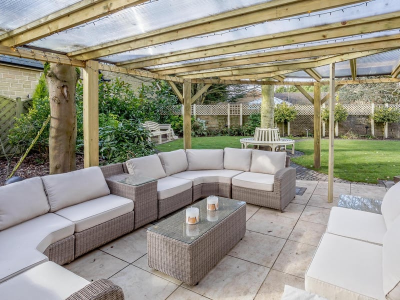 The landscaped rear garden has covered sitting and dining area with remote-controlled patio heaters