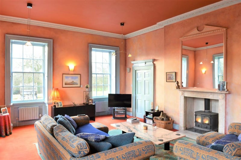 This formal reception room is generous in size; four Georgian sash style windows allow natural light, two offering views to the front aspect and two overlooking the adjacent enclosed courtyard. The focal point of the room is a large fireplace with beautiful marble fire surround and large over mantel mirror featuring a wood-burning stove.
